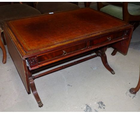 A period style mahogany dwarf sofa/coffee table with inset leather top and frieze drawer