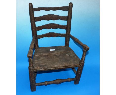 A 19th century child's ladder back carver chair