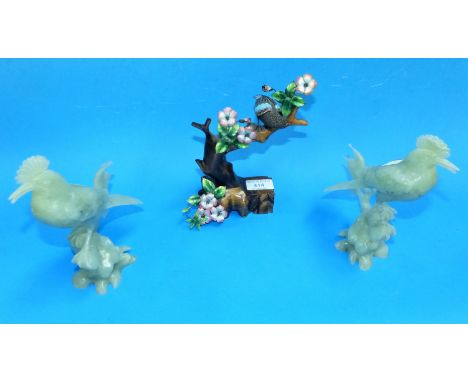 An enamel ad wooden figure, bird on branch with flowers; a pair of jade coloured hardstone figures of birds