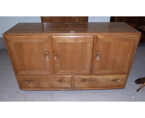 An Ercol light elm sideboard of 3 cupboards and 2 drawers