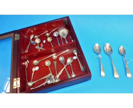 Three Georgian silver teaspoons; a caddy spoon; a collection of miniature and salt spoons in small display case