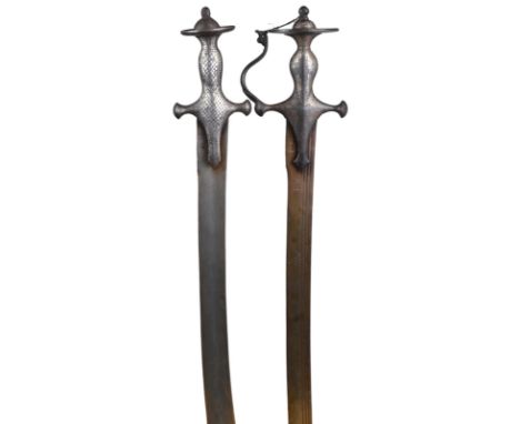 Two Indian swords (tulwar): the first with shallow fullered blade 28.5 in, with small punched marks, iron hilt with silver ko
