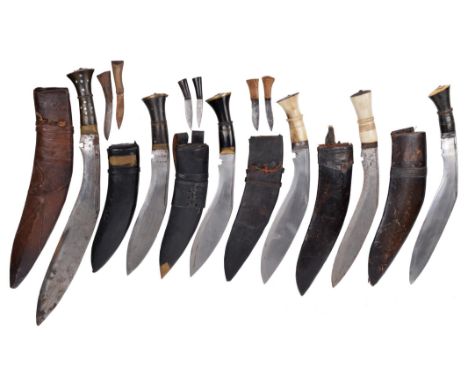 Six Nepalese knives (kukri): a large example with 16.5 in. blade, studded horn hilt, brown leather scabbard with moulded deco