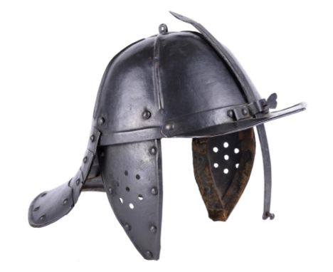 A lobster-tailed helmet, skull formed in one piece with six ridges radiating from the top, tail formed of four plates joined 