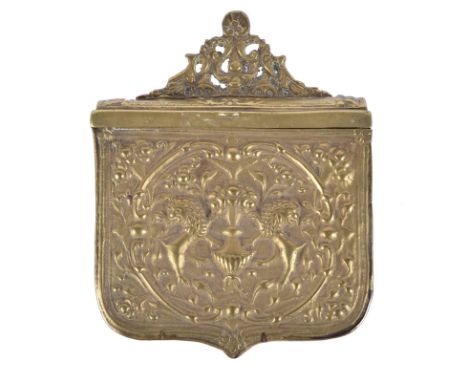 A Greek brass cartridge box, embossed with two lions supporting an urn, hinged lit with pierced finial, belt loop fixed to th