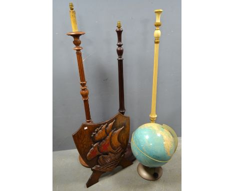 Three standard lamps, The Illumina Globe by Purnell & Sons Ltd. London and an oak firescreen with carved Galleon