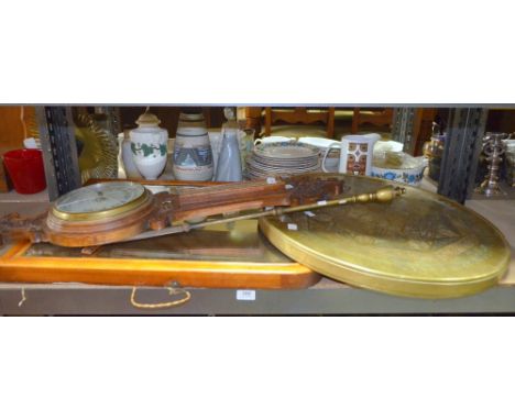 A mahogany mirror with bevelled plate, an aneroid barometer, an eastern brass table top and a brass poker