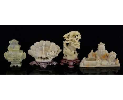 Four Chinese soapstone carvings, the first as a man seated beside a small pool, 6cm high, a peacock, 6.5cm high, squirrels in