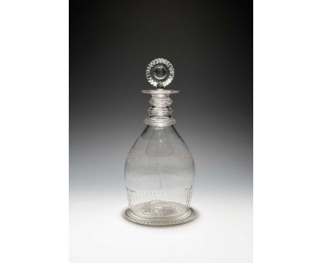 An Irish glass decanter and stopper, c.1820, Waterloo Glass Works of Cork, of Prussian shape, engraved with stylized flowers 