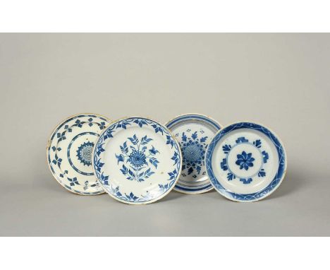 Four delftware plates, c.1720-50, variously painted in blue with stylized flowerheads and geometric motifs within formal and 