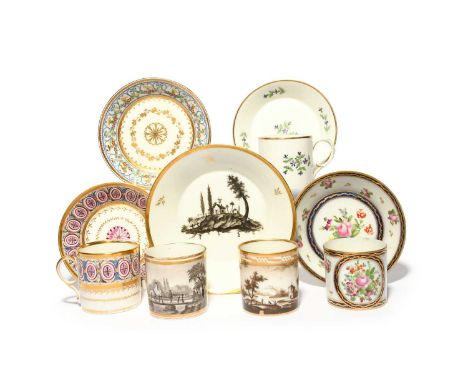 Three Paris porcelain coffee cans and saucers, 19th century, one decorated with an elaborate geometric band, one with a panel