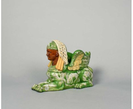 A Grove &amp; Stark (Longton Hall) majolica planter, late 19th century, modelled as a recumbent sphinx, with sgraffito decora