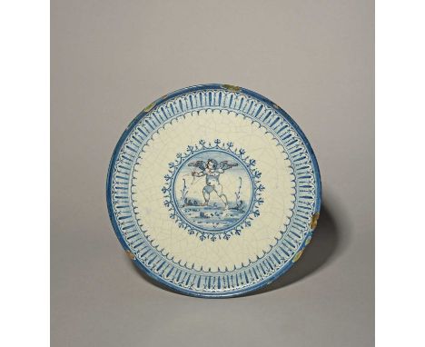 A Delft tazza, last quarter 17th century, painted in blue and manganese with Cupid firing an arrow from his bow, within a for
