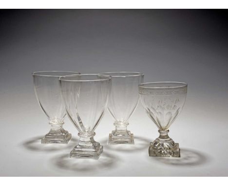 Four glass rummers, early 19th century, three with lightly moulded funnel bowls raised on stepped square feet, the last engra