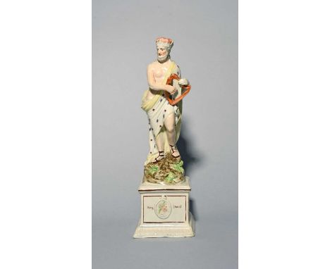 A Wood-type pearlware figure of King David, c.1800, standing atop a rocky base and holding a small Irish harp, raised on a ta