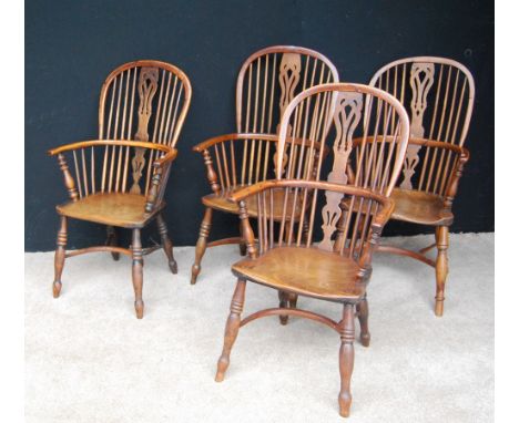 19th century Harlequin set of four yew wood Windsor chairs, each with comb back, pierced central splat, hooped arms terminati