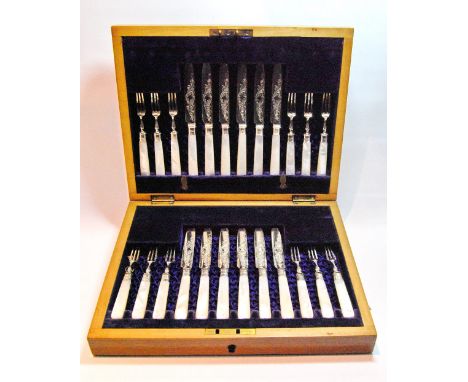 Set of twelve silver dessert knives and twelve forks with pearl handles, by Watson &amp; Gillot, Sheffield 1901, cased.