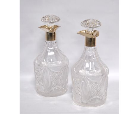 Pair of decanters of Georgian Prussian style, fluted and hobnail cut, with silver triple spout mounts, Sheffield 1931. Condit