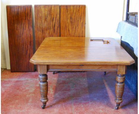 Late Victorian mahogany extending dining table, the moulded rectangular top with canted corners, raised on baluster turned le