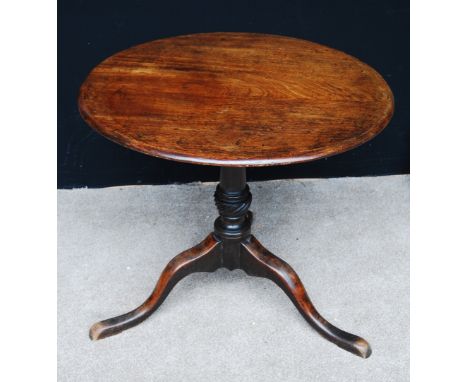 Georgian mahogany pedestal table, the oval tilt top raised on baluster column and tripod cabriole legs, 76cm wide, 69cm high 