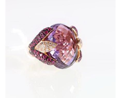 18ct gold amethyst and ruby-set cocktail ring with central faceted amethyst and diamond-set shoulders.