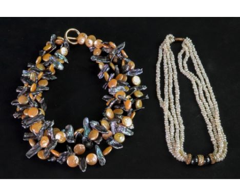 A four-strand cultured pearl choker necklace, suspended from a diamond set flattened disc bead, between two hematite beads an