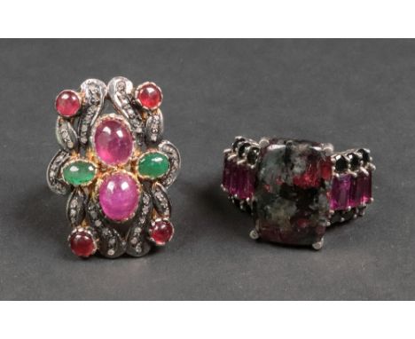 A silver gilt, cabochon ruby, emerald and diamond-set dress ring of pierced rectangular plaque design, set with two cabochon 