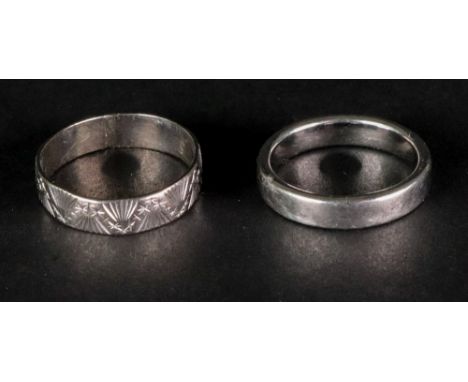 A platinum band ring size L, 7.3g; and an 18ct white gold band ring of textured design, ring size O weight 2.7g (2).