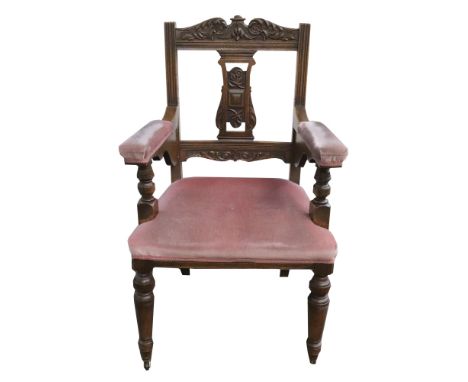 A set of six late Victorian light oak dining chairs, with foliate carved top rails and shaped pierced splats, stuff-over seat