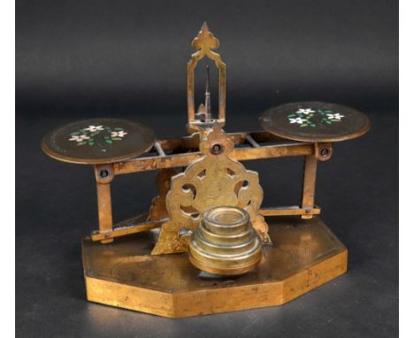 A set of Victorian engraved brass postal scales and weights, the pans enamelled with flowers, octagonal base, 17cm wide.
