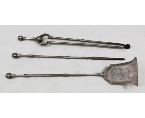 A set of three Victorian steel fire tools, with acorn finials, the shovel of pierced bell shape, 76cm high.
