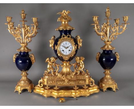 Tessier Rue St Honore 362 Paris; an ornate gilt metal mounted cobalt blue porcelain clock garniture, late 19th century, with 