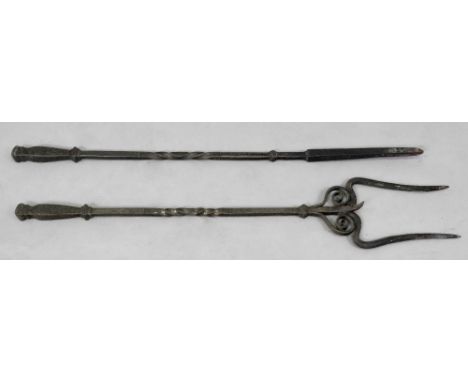 A large wrought iron poker and toasting fork, with twisted square section handles, 83cm high, a large arched wrought iron and