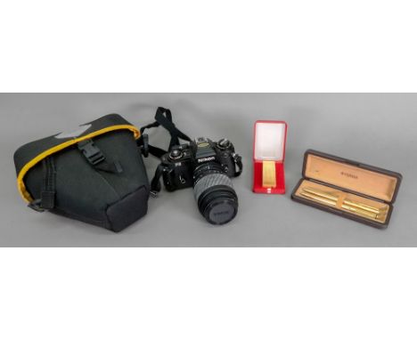 A Nikon FG camera with Sigma zoom lens, Parker ballpoint pen and propelling pencil and a Japanese lighter, cased (4).