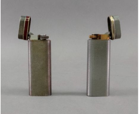 A Cartier lighter, engine turned with repeated faceted squares, with an entwined three-colour band, no. 99421 S and another s