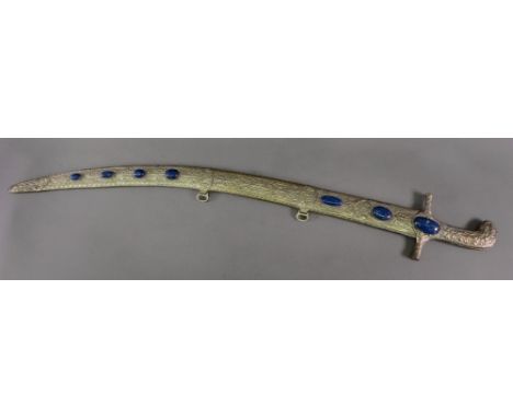 An Islamic silvered metal sword grip and scabbard, foliate embossed within gadroon borders and set with seven lapis lazuli ca