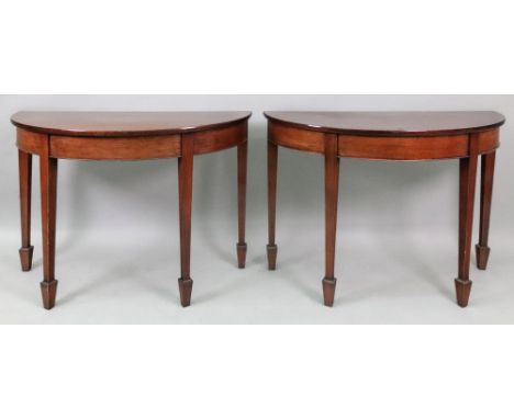 A pair of George III style mahogany demi lune console tables, 81cm wide x 33.5cm deep x 60cm high.