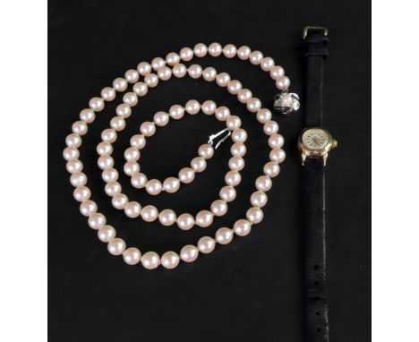 Titus: a lady’s 18ct gold cased wristwatch, the circular white dial with gilt metal baton indicators and Arabic numbers to a 