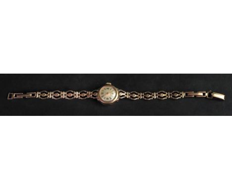 A lady’s 9ct gold wristwatch, the circular silvered dial, with Arabic numbers and baton indicators, to a manual wind movement