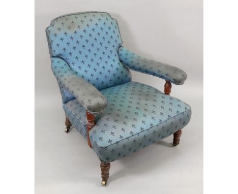 A late Victorian walnut frame armchair, with upholstered back, seat and armrests, on ring turned legs and castors, stamped '1