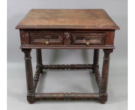 A late 17th century oak side table, with two block moulded front frieze drawers, on gun barrel turned legs united by ring tur