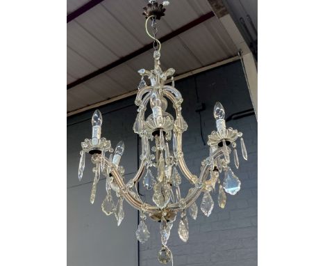 An Italian glass six-light chandelier, 20th century, with scrolling branches and hung with faceted drops, 75cm drop.