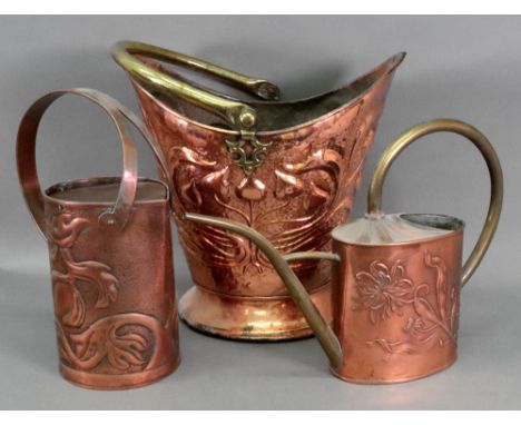An Art Nouveau copper coal helmet, with brass swing handle, the sides foliate embossed against a cell ground, weighted base, 