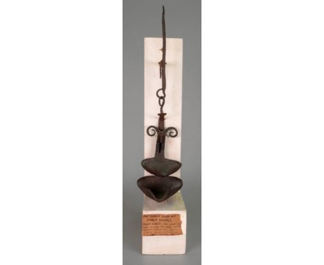 A wrought iron crusie lamp, 18th century, 32cm high, mounted on a painted wooden stand.
