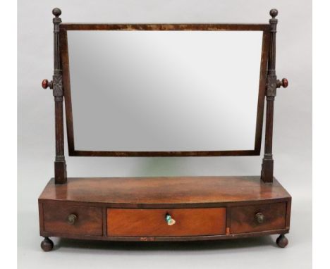 A late Regency mahogany and banded rectangular swing toilet mirror, with ring turned and reeded uprights carved with flowers,