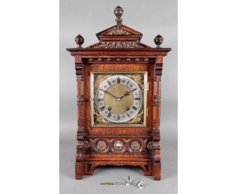 Lenkirch; a late 19th century carved oak gilt metal mounted mantel clock, of architectural style, the gilt metal dial with si