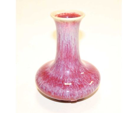 A Chinese export vase, having a flared rim to a slender neck and squat circular body, on circular footrim, flambé glazed in m