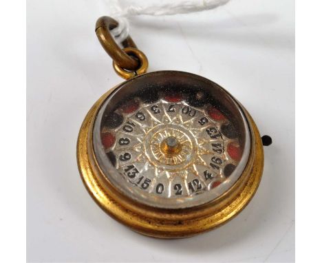A gilt metal cased roulette wheel pendant, dia.23mmCondition report: Light wear but generally in good condition.,