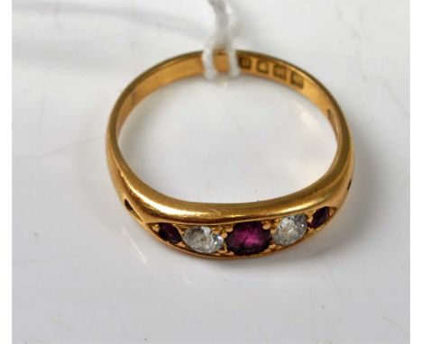 An Edwardian 18ct gold, ruby and diamond set five stone ring, 4.2g, size S