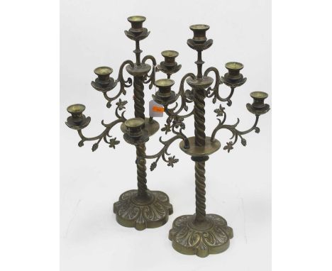 A pair of 19th century brass five sconce table candelabra with foliate decoration, each standing on  a spirally turned column